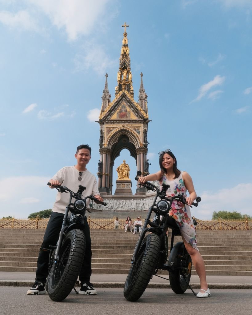 Couple posing with Super73 electric bikes outside the Albert Memorial during a premium guided London e-bike tour.