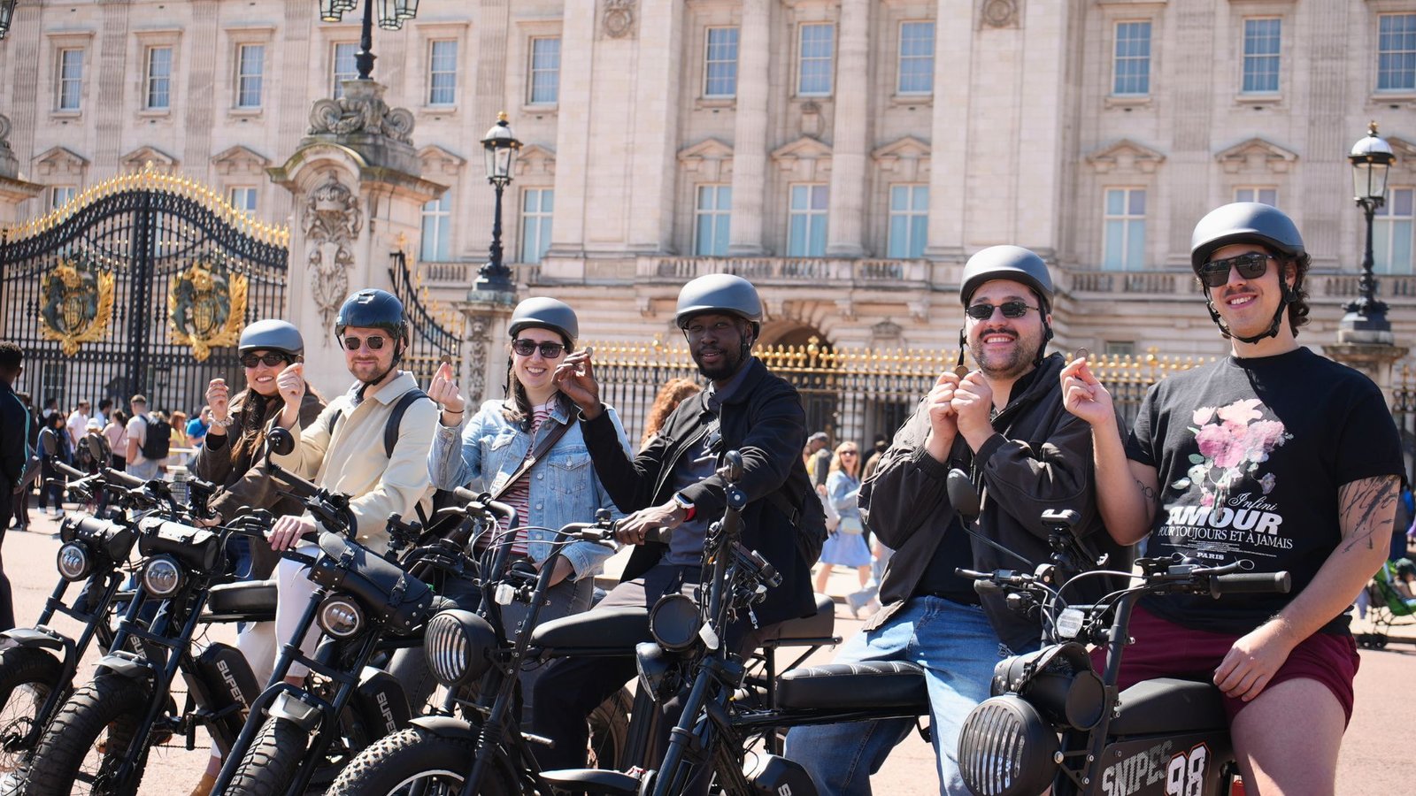 Small group outside Buckingham Palace during a Royal London e-bike tour with FOF Bike Tours, riding premium Super73 electric bikes.